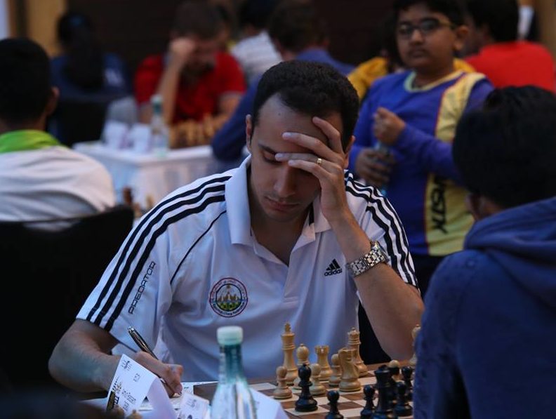 Visually impaired chess player Darpan Inani shows his opponents he
